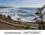 View from above of the parking area and beautiful ocean landscape. Location is Quarry Cove in Yaquina Head State Park in Oregon