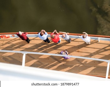 View From Above: Passengers Of A Cruise Ship Wave Goodbye As They Leave The Port