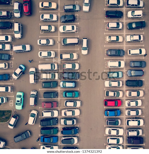 A view from above to the ranks of head-in parked
cars.End-to-end parking. Cruising for parking space. Trouble-free
navigation in the parking lots. Problem of space for a parked
vehicle. Busy parking