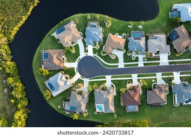 View from above of residential houses in living area in North Port, FL at evening. Illuminated American dream homes as example of real estate development in US suburbs