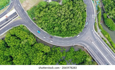 View From Above Of Ring Road Toll Way Structure Blend With Group Of Green Tress On The Side.