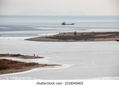 View From Above. Sea Barge Floats In The Ice In Vladivostok. Winter Shipping.