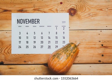 View from above to simple November 2019 calendar decorated with pumpkin - Shutterstock ID 1552063664