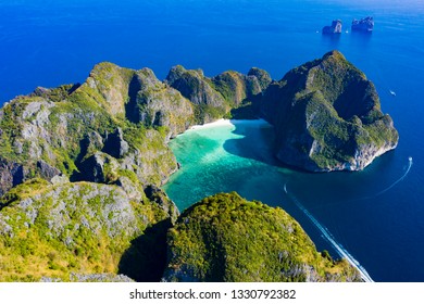View from above, stunning aerial view of Koh Phi Phi Lee with the beautiful beach of Maya Bay bathed by a turquoise clear water. Amazing limestone karst formations surround this island in Thailand.