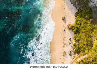 View From Above, Stunning Aerial View Of A Rocky Shore With A Beautiful Beach Bathed By A Rough Sea During Sunset, Nyang Nyang Beach (Pantai Nyang Nyang), South Bali, Indonesia.