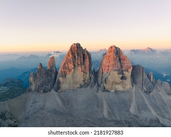 View from above, stunning aerial view of the Three Peaks of Lavaredo (Tre cime di Lavaredo) during a beautiful sunrise. The Three Peaks of Lavaredo are the undisputed symbol of the Dolomites, Italy. - Shutterstock ID 2181927883