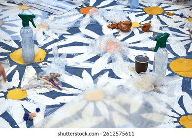 A view from above of the table with a daisy pattern, where a master class on felting toys from wool is taking place