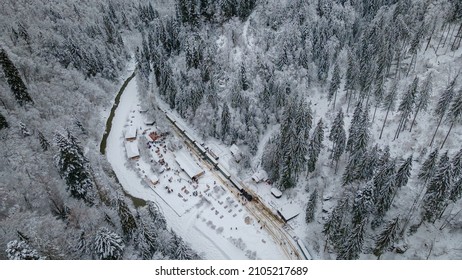 View from above of a touristic train station located in Maramures county, Romania, Shot from a high altitude in winter season. Aerial view of a narow gauge steam train station.