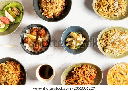 View from above of various Asian food dishes, rice, noodles and spring rolls. High quality photo