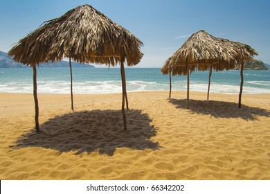 View of Acapulco Bay on a sunny day with beach cabanas - Powered by Shutterstock