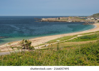 View across bay and sandy beach to Fort Grosnez and Braye Harbour from Fort Tourgis under blue sky, Alderney, Channel Islands - Shutterstock ID 2166057495