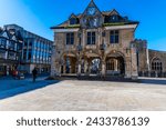 A view across the cathedral square towards the Guildhall and shops in Peterborough, UK on a bright sunny day
