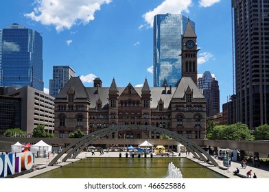 View Across The Fountain On Nathan Phillips Square With Old City Hall And Cadillac Fairview Tower In The Background. Toronto, Canada. 2016/06/27