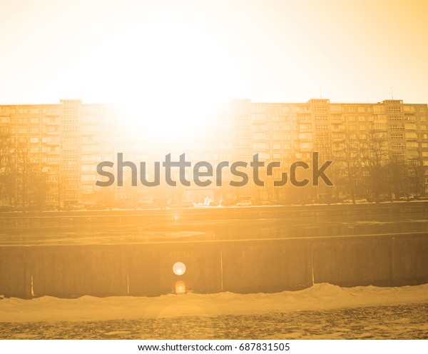 The view across the river to the house in the\
Park in winter sunset\
