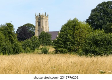 View across summer grass of historic St Mary the Virgin Church Shawbury
