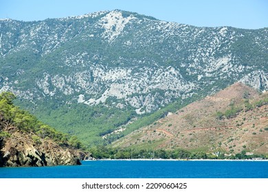 The View Of Adrasan Resort Town Beach With A Tall Mountain Behind (Turkey).