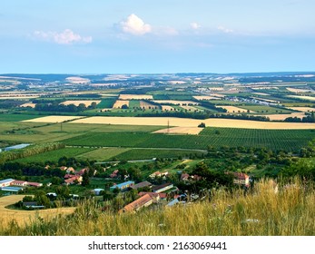 A view of the agricultural landscape of South Moravia around Mikulov and Pálava. Fields and vineyard under blue summer sky. Suitable for tourist advertising.