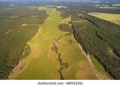 View from air on green meadow and forest. Ukrainian village - aerial view. Aerial view of a green rural area under blue sky - Shutterstock ID 689531341