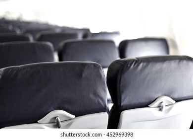 View Of Airline Seat Backs With Tray And Head Rest