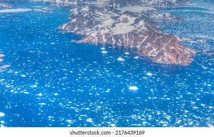 View From Airplane Of Melting Polar Ice Cap And Snowy Mountains - Greenland