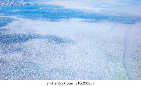 View From Airplane Of Melting Polar Ice Cap And Snowy Mountains - Greenland