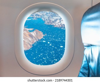 View From Airplane Of Melting Polar Ice Cap Greenland As Seen Through Window Of An Commerical Passenger Airplane