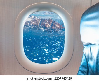 View From Airplane Of Melting Polar Ice Cap Greenland As Seen Through Window Of An Commerical Passenger Airplane