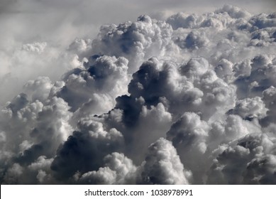 View from airplane window above the dramatic clouds with blue sky and cloudscape in sunlight morning. white wispy cirrus and cirrostratus clouds. Cumulus clouds - Powered by Shutterstock - Get 15% off with code: PIKWIZARD15