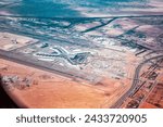 View from an airplane window at Abu Dhabi international airport, streets, roads and residential buildings of the city