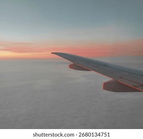 View from the airplane window. Beautiful cloudscape with sunset. Wonderful panorama above white clouds as seen through window of an plane.