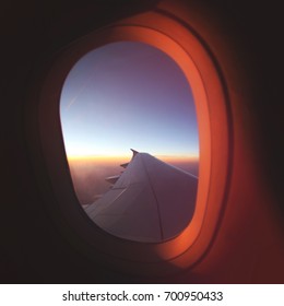 View From Airplane Window At Beautiful Sunrise. Luxery Travel Plane Concept.