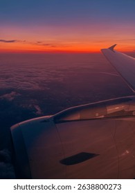 The view from a airplane window to clouds and sunset.