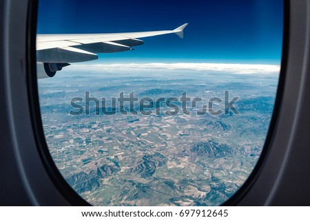 View from airplane window on circled fields