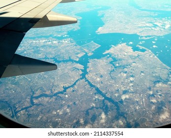 View from an airplane window on a clear cloudless day. Looking down by the right-wing side, while flying over the East coast of the USA. No people or recognizable trademarks. Taken in December.