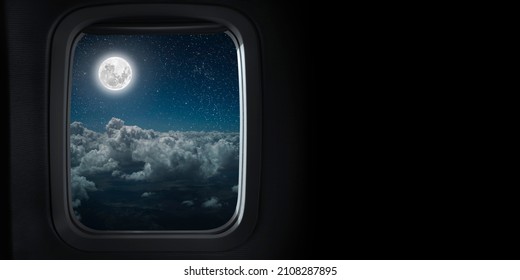 the view from the airplane window on the night sky - Powered by Shutterstock