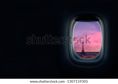 View from airplane window at sunset of the Paris. Eiffel tower in view, travel to paris concept for travel agency