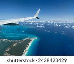 View of airplane wing above the hotel zone on the coastline of Cancun, Quintana Roo, Mexico