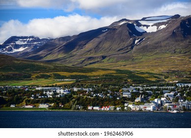 View Of Akureyri, The Country's Second Largest City, Dwarfed By Mountains Across The Eyjafjörður Fjord, North Iceland