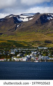 View Of Akureyri, The Country's Second Largest City, Dwarfed By Mountains Across The Eyjafjörður Fjord, North Iceland