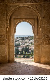 View of the Albayzin district of Granada, Spain, from an arched window in the Alhambra palace near sunset at Granada, Spain, Europe on a bright sunny day