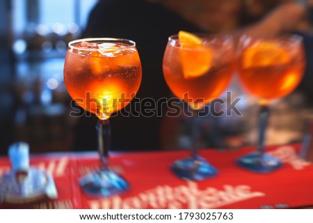 View of alcohol setting on catering banquet table, row line of red colored aperitif alcohol cocktails on a party, negroni and spritz, vodka, and others on decorated catering table event, bartender 