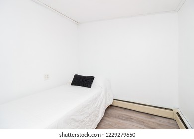 View Of All White Bedroom With Black Pillow