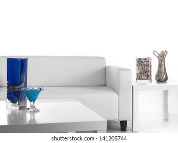 View Of A All White Living Room With Glass Vase On The Coffee Table.