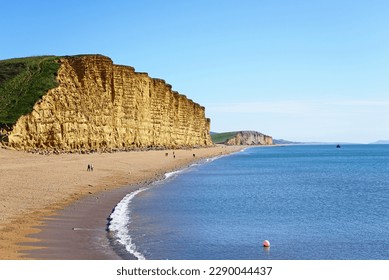 View along the beach and Jurassic Coast coastline, West Bay, Dorset, UK, Europe. - Shutterstock ID 2290044437