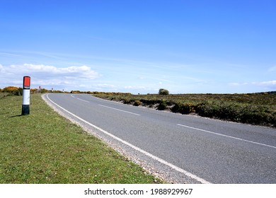 view along open road through moorland. Summer day with blue sky