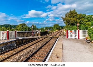 A view along the railway platform at Settle, Yorkshire in summertime - Shutterstock ID 2061165650