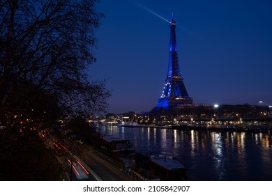 View along the Seine with Eiffel tower dressed in European flag lighting for the French presidency