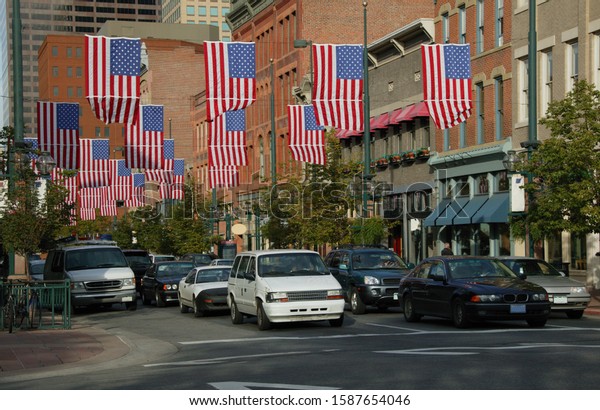 View of American flags hanging\
between buildings in Larimer Street, Denver, Colorado,\
USA