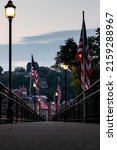 A view of American flags on grant park pedestrian bridge at sunset in Galena, Illinois, United States