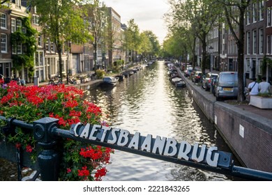 View Of Amsterdam Canal In A End Summer Day, With The People And Life Of This Funny City